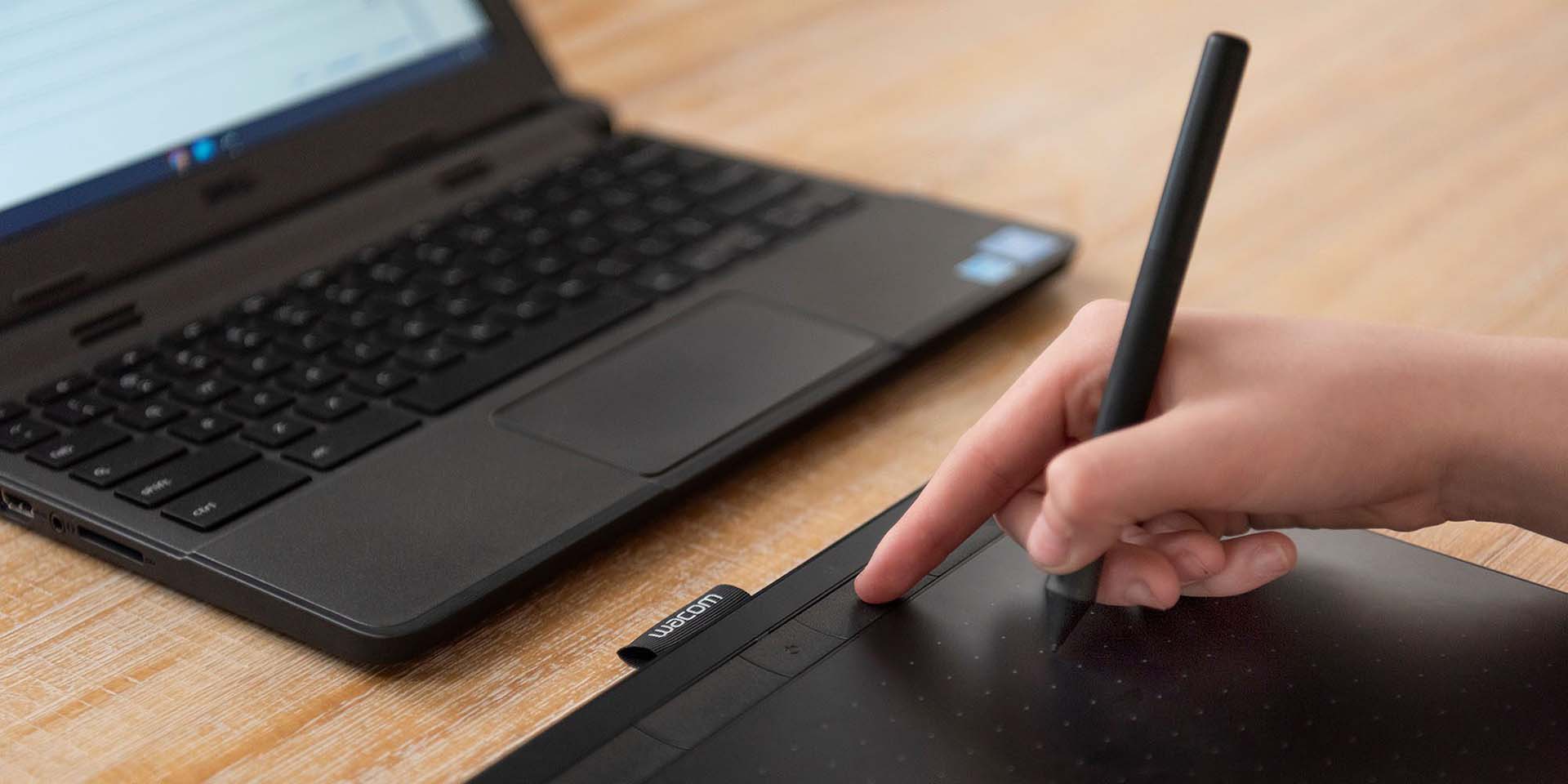 Wacom Intuos finger pressing ExpressKey with pen in hand